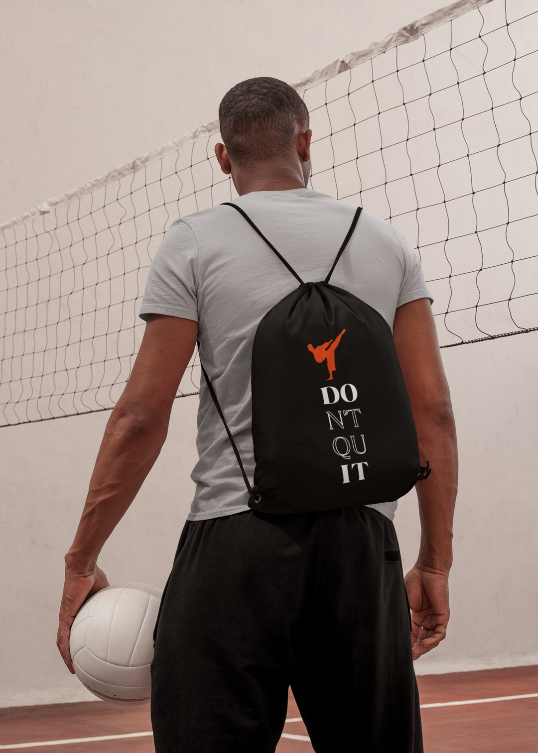 Man wearing karate bag with kick symbol