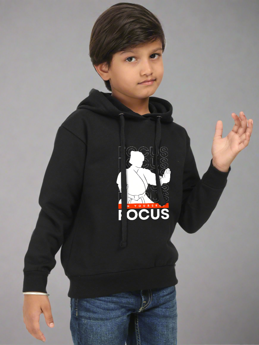 Child wearing a black hoodie with a graphic design on a gray background