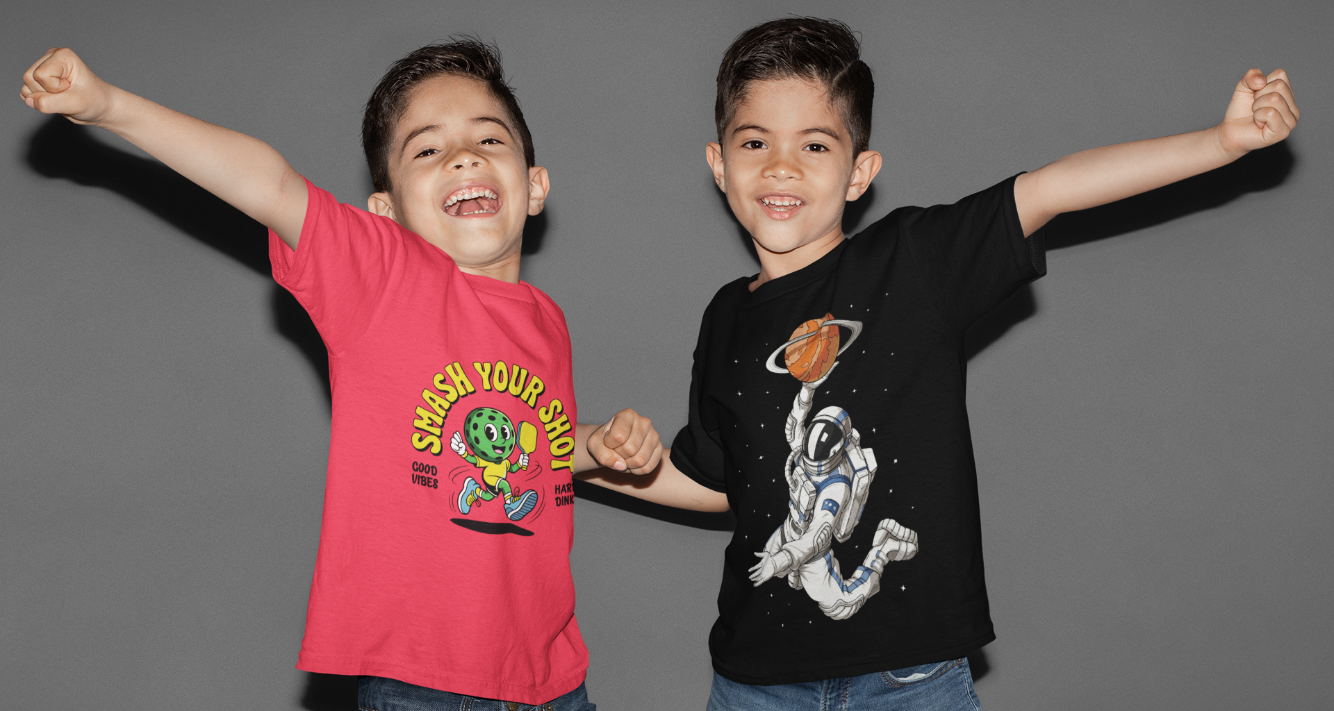 Two children wearing colorful t-shirts with graphic designs against a gray background